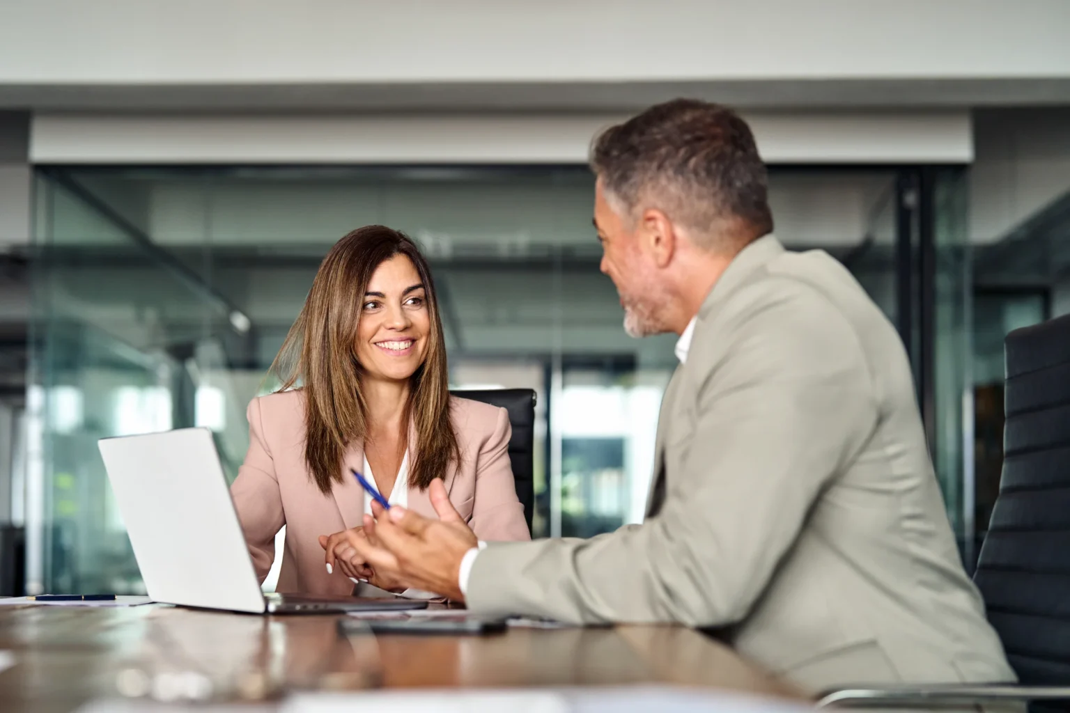 An insurance advisor talking with a client across a desk